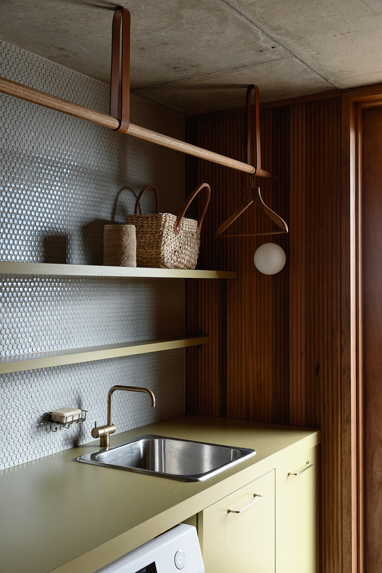 A sink and shelves in a laundry.