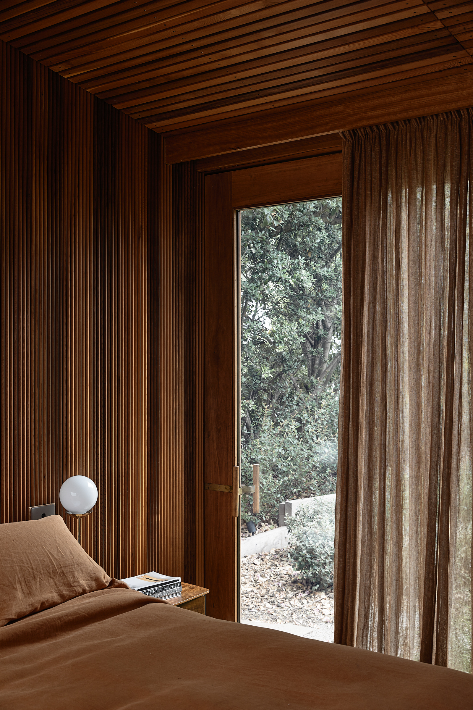 A bedroom with a view to the garden.