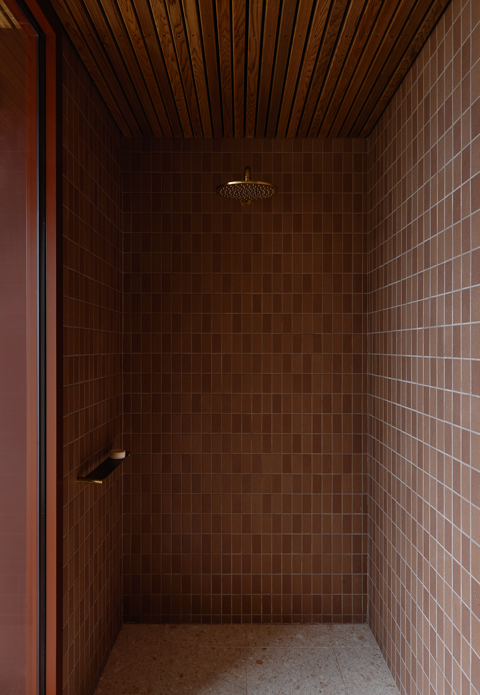 A shower with a shelf.