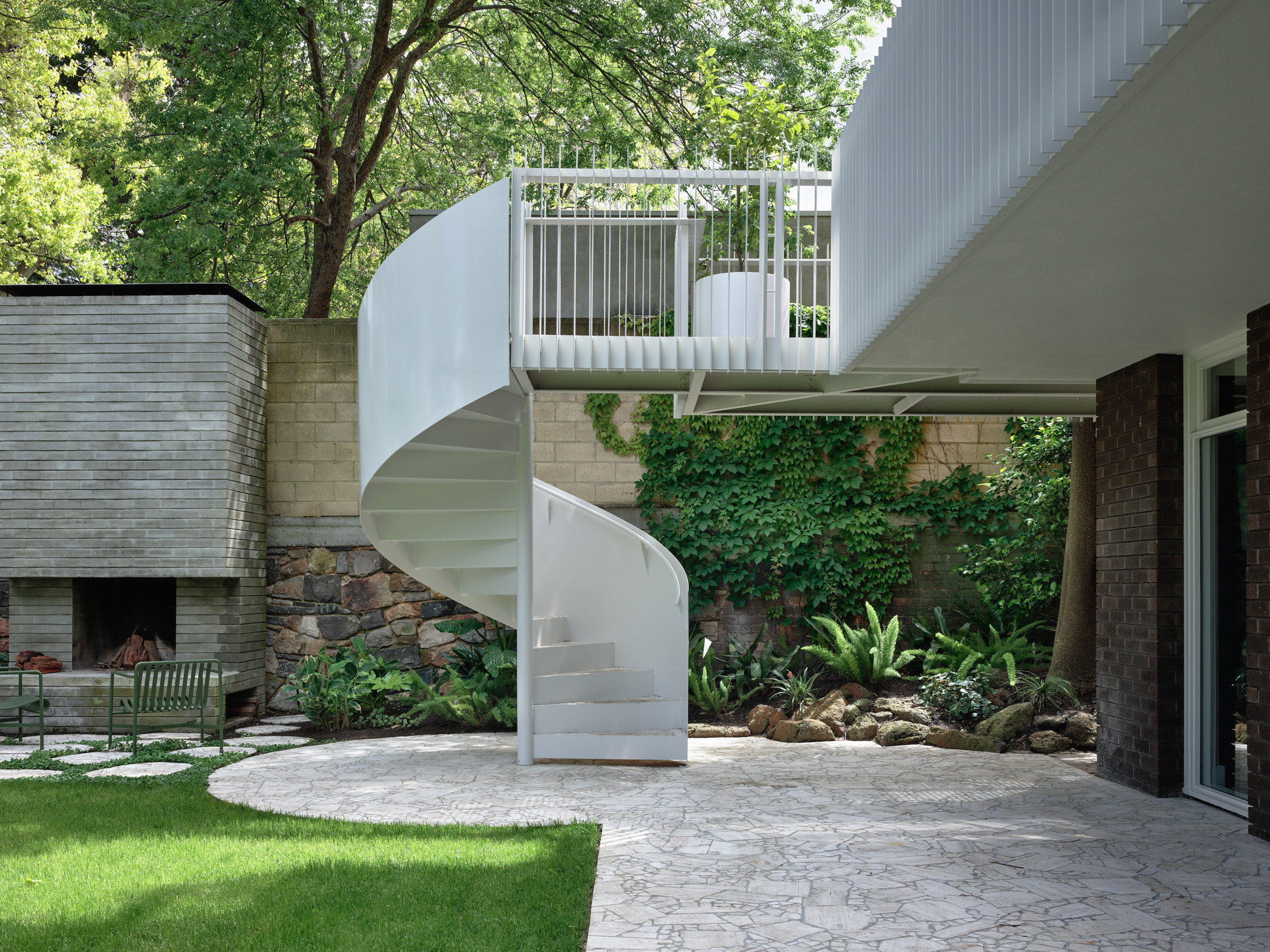 A spiral staircase in a backyard.