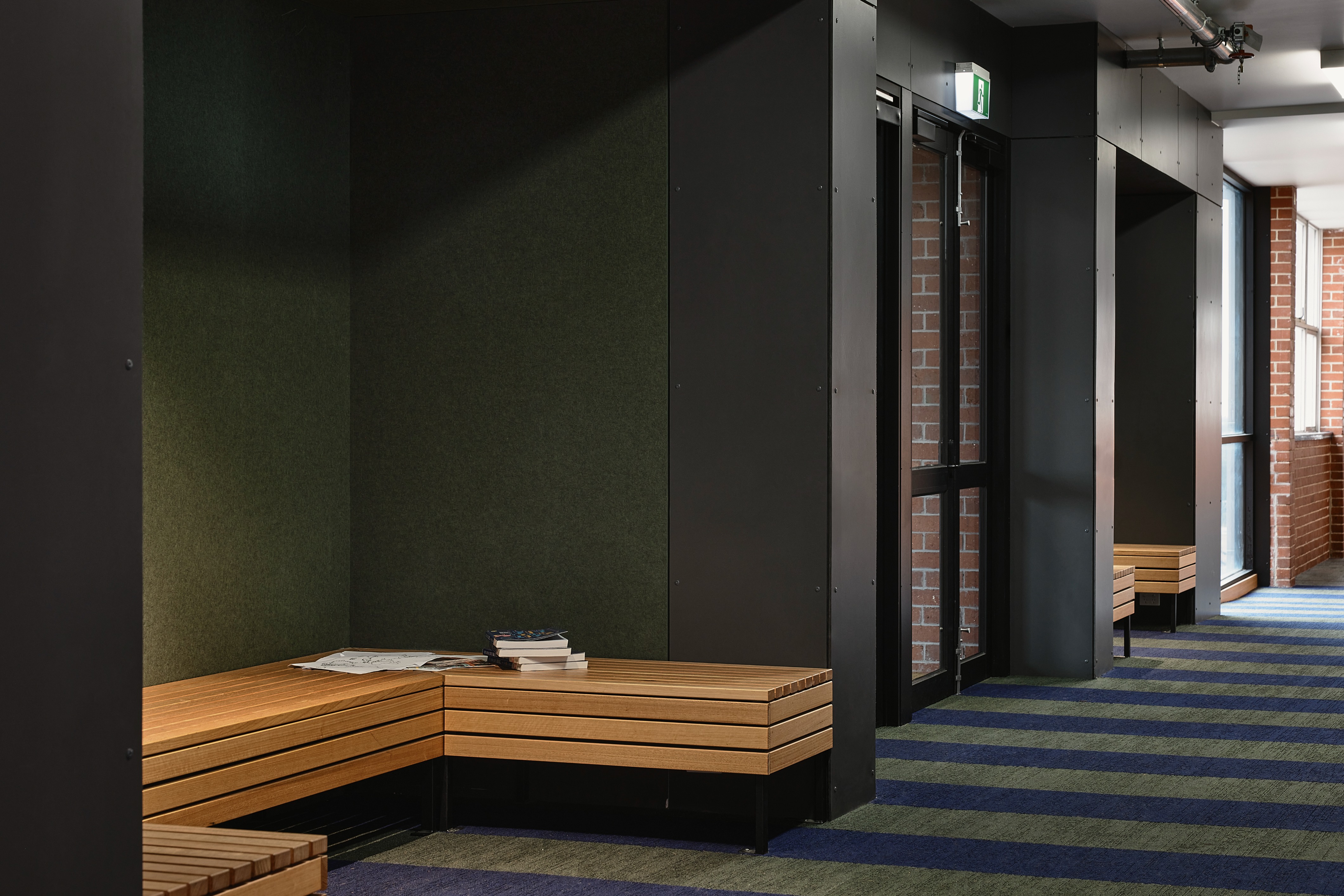 A wooden bench in an alcove for reading.