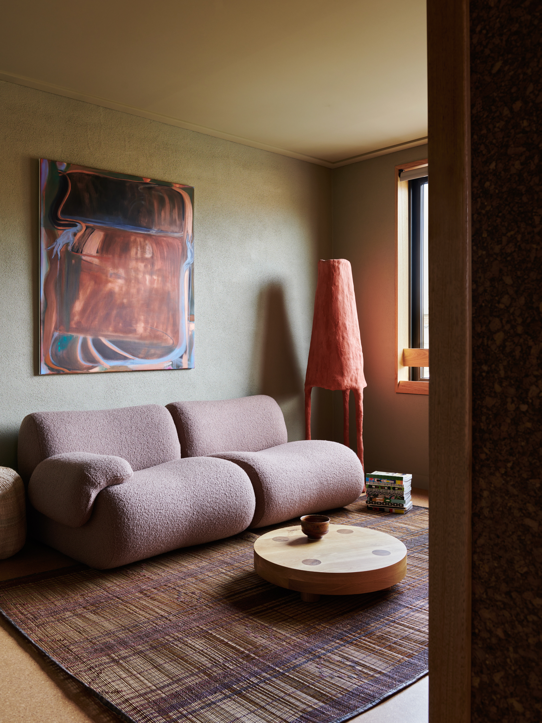 A couch, rug, and lamp in a living room