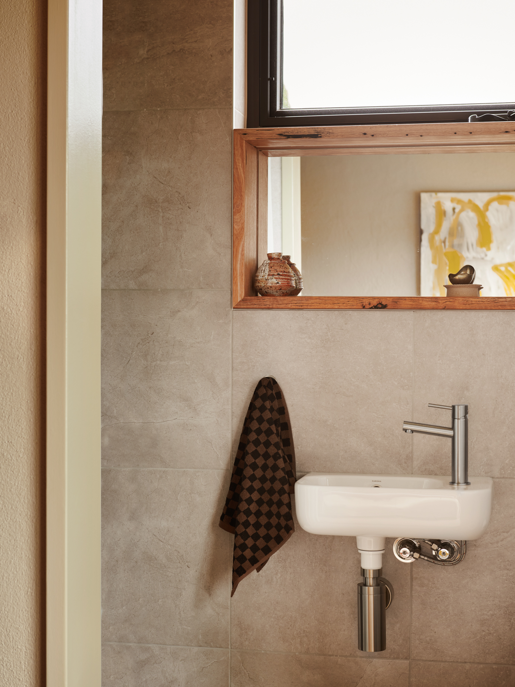 A bathroom sink and shelf with mirror.