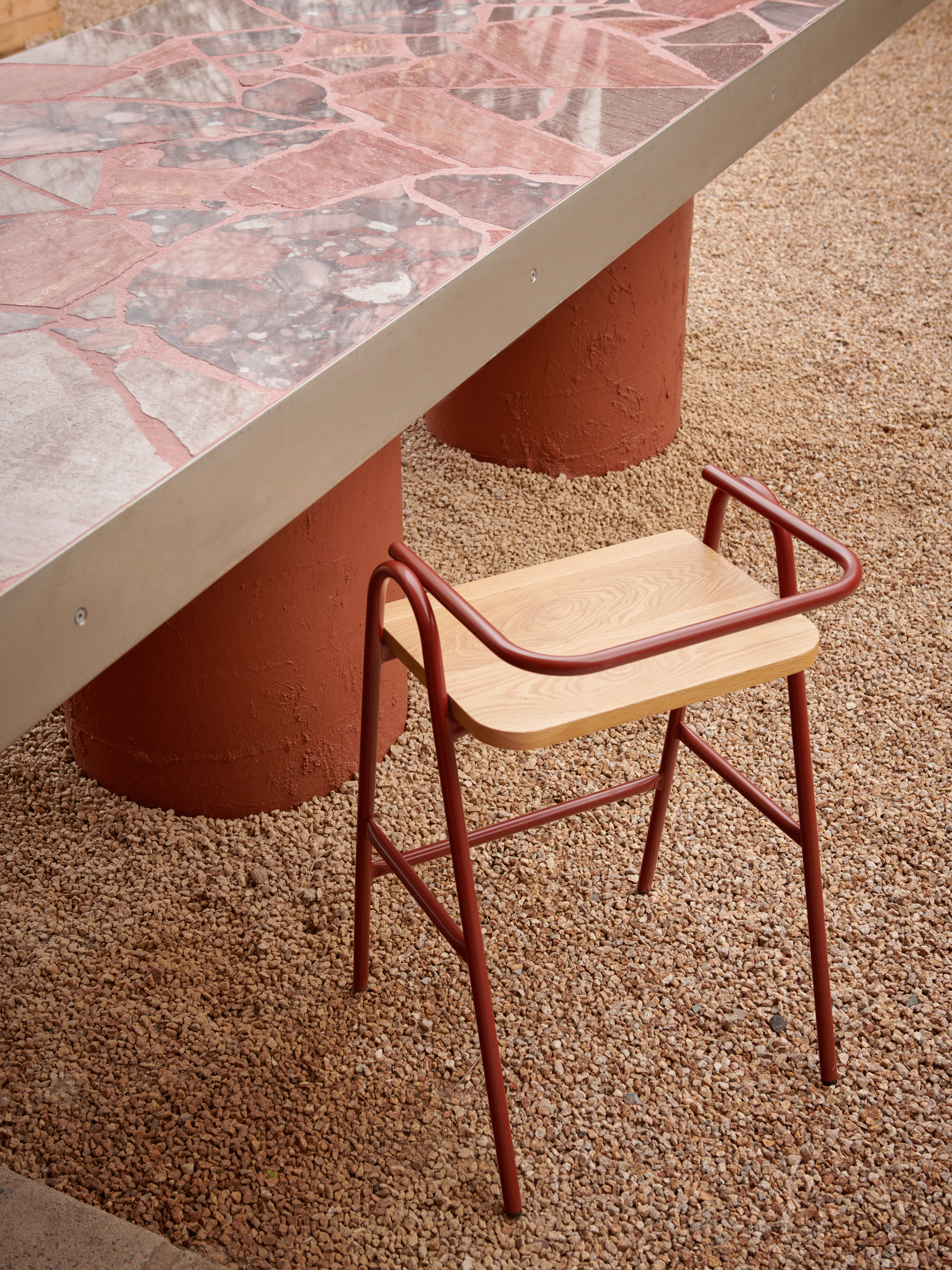 A stool next to a tiled table.
